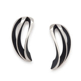These angel twist earrings in silver are like curved wings with oxidised recesses to accentuate the design.  Angel twist earrings by Sarah Herriot.