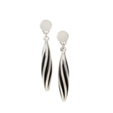 Beat twist drop earrings have a rhythmic twist and oxidised recesses to accentuate the design in silver. Beat twist drop earrings by Sarah Herriot.