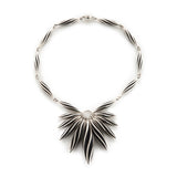 beat twist star neckpiece in silver with oxidised recesses by Sarah Herriot.