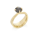 Elegant twisted collet rises to hold a rose cut black diamond in this 18ct gold Twist and Taper ring. Twist and Taper ring by Sarah Herriot.