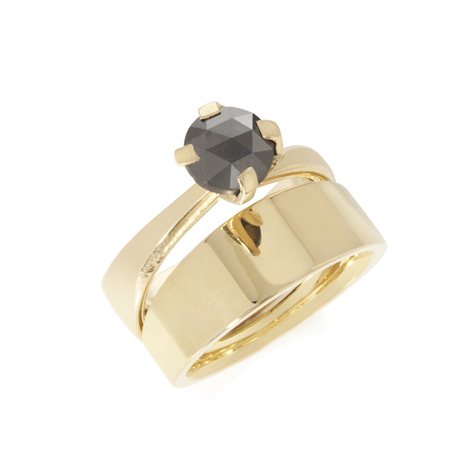 Elegant twisted collet rises to hold a rose cut black diamond in this 18ct gold Twist and Taper ring. Twist and Taper ring by Sarah Herriot.