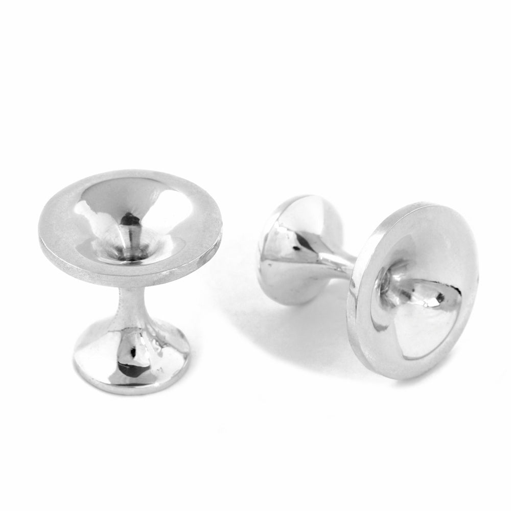 These striking cufflinks feature a distinctive vortex design that does right through the piece, crafted from polished silver, making them an intriguing choice for those who appreciate contemporary jewellery with conceptual appeal. Black hole cufflinks by Sarah Herriot.