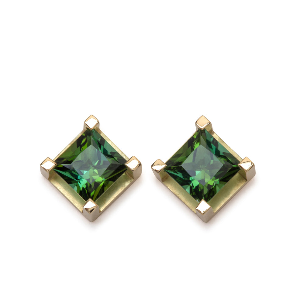 Crane stud earrings sit proud from the ear, holding gorgeous square green/turquoise tourmalines in 18ct gold frames. Crane earrings by Sarah Herriot.