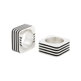 The cube ring is formed of silver sheets with oxidised recesses to accentuate the strong linear shape with curved corners.  Cube ring by Sarah Herriot.