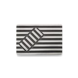 Deck chair brooch in silver made of linear construction with an opposing rectangular inset, blackened recesses accentuate the design. Deck chair brooch by Sarah Herriot.