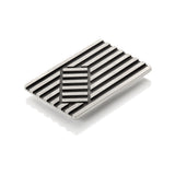 Deck chair brooch in silver made of linear construction with an opposing rectangular inset, blackened recesses accentuate the design. Deck chair brooch by Sarah Herriot.