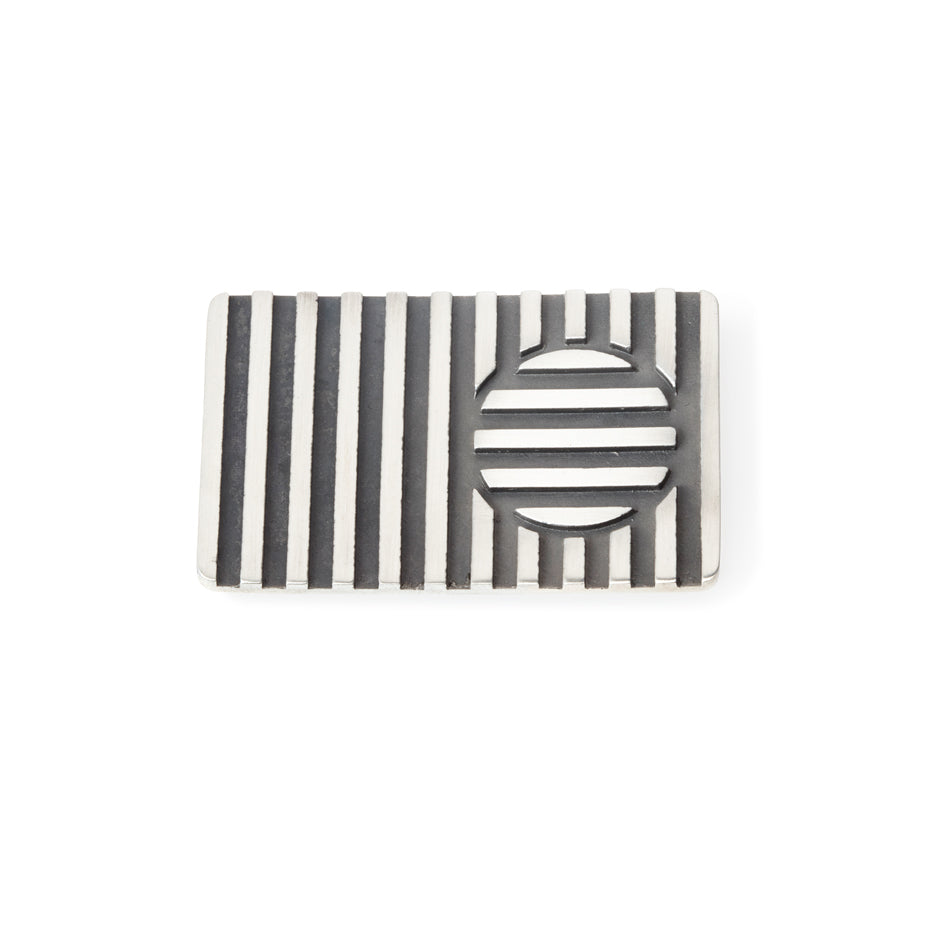 Disc brooch in silver with oxidised recesses by Sarah Herriot.