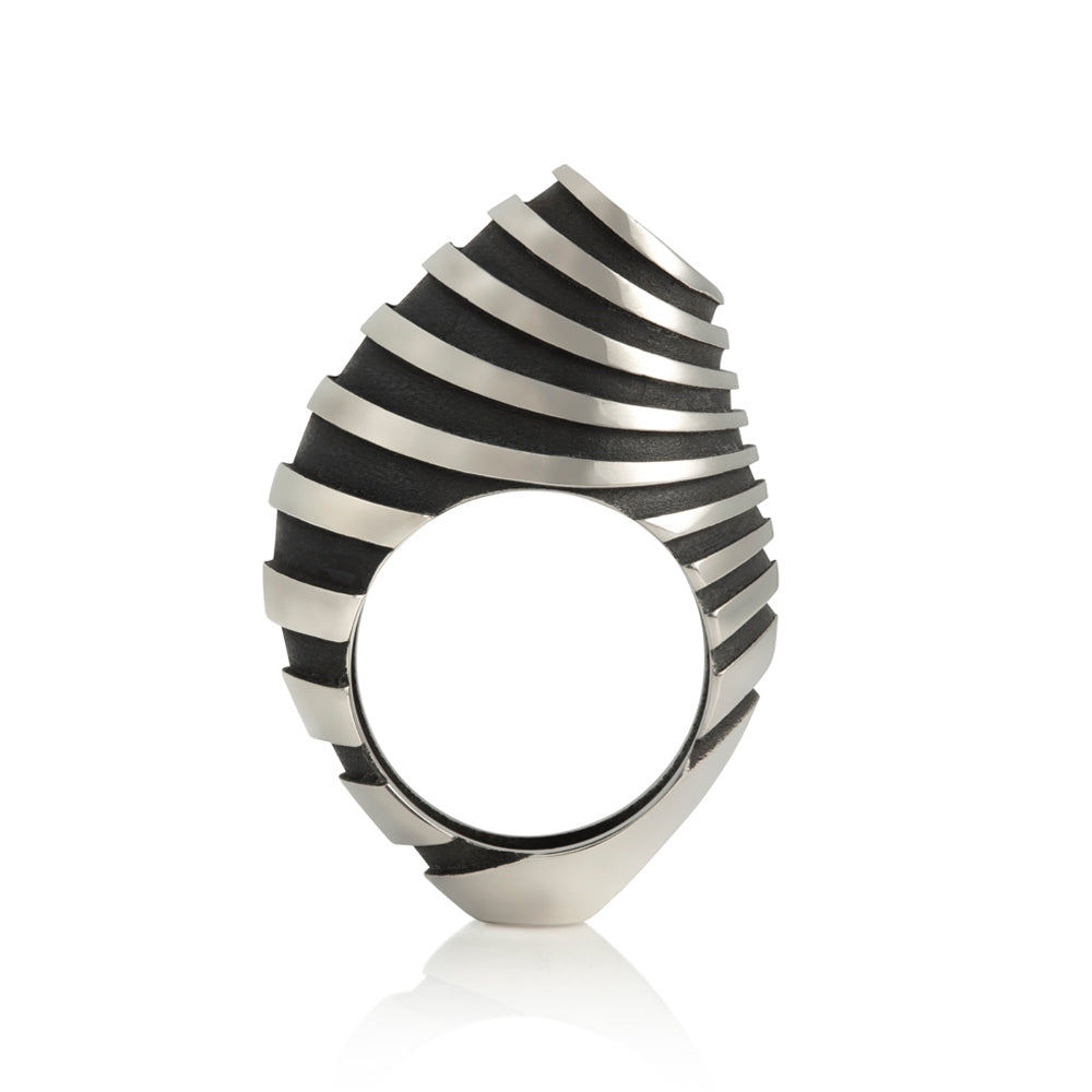 Eddy ring is a free form sculptural ring design with looping tapered bands accentuated by oxidised recesses. An abstract form with linear deconstruction. Eddy ring by Sarah Herriot.