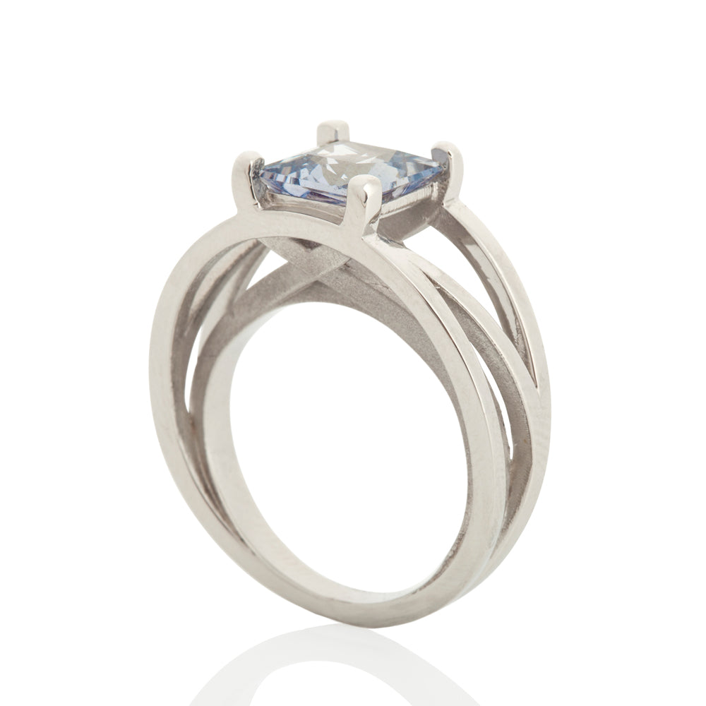 Crane ring in platinum with square grey/blue sapphire by Sarah Herriot.
