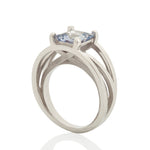 Crane ring in platinum with square grey/blue sapphire by Sarah Herriot.