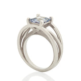Crane ring in platinum with square grey/blue sapphire by Sarah Herriot.