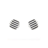 Escalator stud earrings have a polished wave surface and oxidised recesses to create a modern structure in silver. Escalator stud earrings by Sarah Herriot.