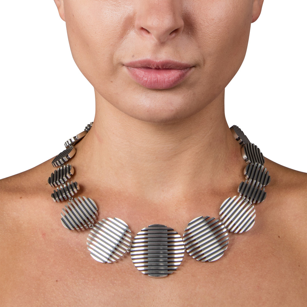 Escalator neckpiece in brushed and oxidised silver by Sarah Herriot.