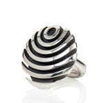 The fish button ring is formed of strong linear curves creating a bold design in silver, the oxisided recess help to accentuate the form.  Fish button ring by Sarah Herriot.