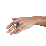 The fish button ring is formed of strong linear curves creating a bold design in silver, the oxisided recess help to accentuate the form.  Fish button ring by Sarah Herriot.