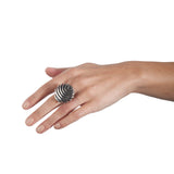 The fish button ring is formed of strong linear curves creating a bold design in silver, the oxisided recess help to accentuate the form.  Fish button ring by Sarah Herriot.