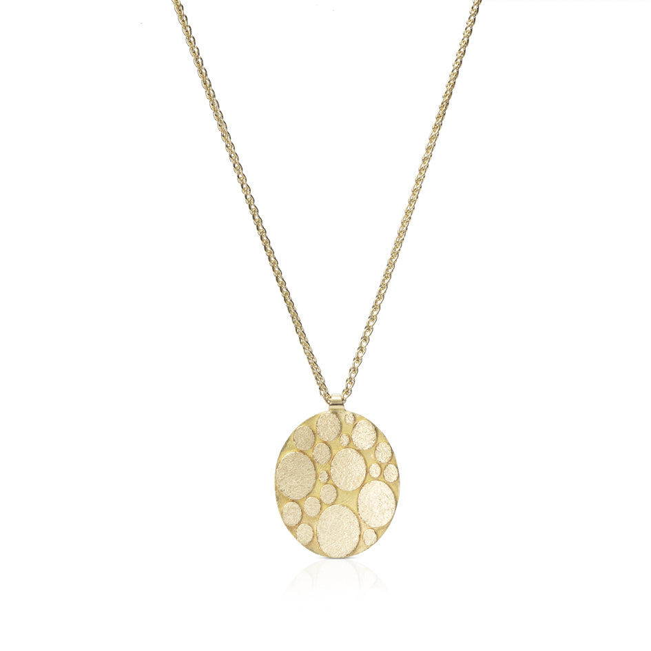 Galaxy necklace is an elegant construction using oval motif in 18ct gold. Sarah's imagining of the night sky, packed full of stars, as it was in her childhood in New Zealand. Her design runs through both sides of the surface, one side convex, the other concave. Galaxy necklace by Sarah Herriot.