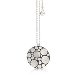 Galaxy pendant is an elegant construction using circle motif in sterling silver. Sarah's imagining of the night sky, packed full of stars, as it was in her childhood in new zealand. Her design runs through both sides of the surface, one side convex, the other concave. Galaxy pendant by Sarah Herriot.