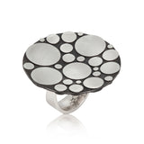 Galaxy ring is an elegant construction using circle motif in sterling silver.  Sarah's imagining of the night sky, packed full of stars, as it was in her childhood in New Zealand. Galaxy ring by Sarah Herriot.
