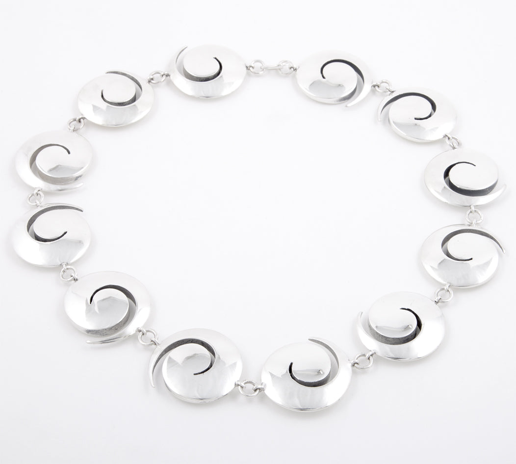 Koru neckpiece in silver with oxidised recesses by Sarah Herriot.