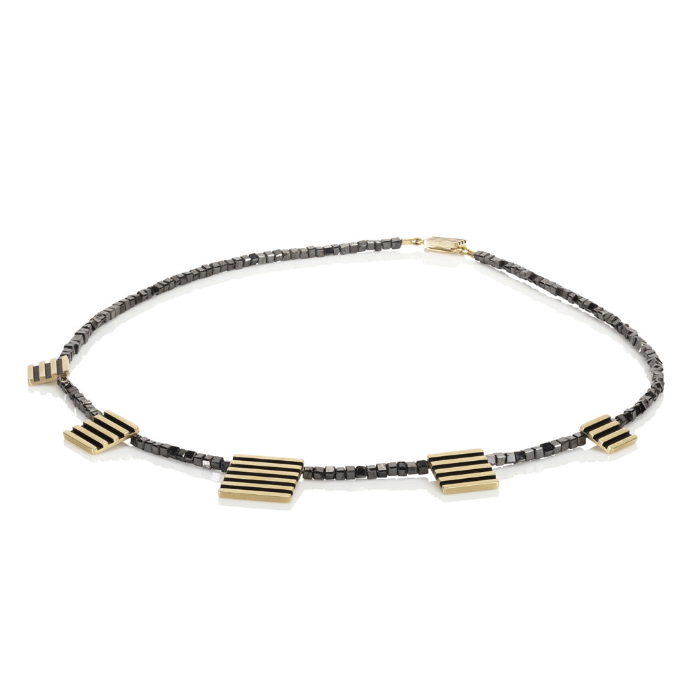 Black diamond cube neckpiece with linear 18ct gold pieces by Sarah Herriot.