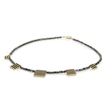 Black diamond cube neckpiece with linear 18ct gold pieces by Sarah Herriot.