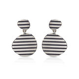 These silver op earrings really pop when worn, eye catching and lots of fun. They frame that face beautifully and will hang differently when swapped around.Op earrings by Sarah Herriot.