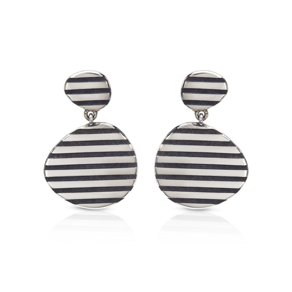 These silver op earrings really pop when worn, eye catching and lots of fun. They frame that face beautifully and will hang differently when swapped around.Op earrings by Sarah Herriot.