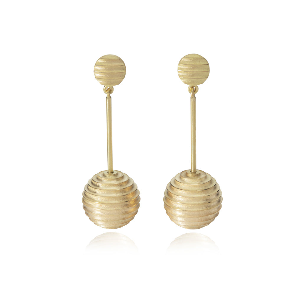 Lunar earrings, studs fitting with an elegant long drop finished with a hollow sphere formed of an undulating texture in 18ct gold.  Lunar earrings by Sarah Herriot.