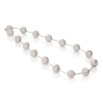 This striking neckpiece features hollow silver spheres inspired by planetary forms, creating an architectural statement piece with surprising lightness. The sculptural design balances bold visual impact with wearable comfort. Each sphere is meticulously crafted to catch light beautifully, adding dimension to any ensemble. A playful yet sophisticated addition to any collection, this piece celebrates celestial beauty through contemporary design. Lunar neckpiece by Sarah Herriot.
