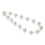 This striking neckpiece features hollow silver spheres inspired by planetary forms, creating an architectural statement piece with surprising lightness. The sculptural design balances bold visual impact with wearable comfort. Each sphere is meticulously crafted to catch light beautifully, adding dimension to any ensemble. A playful yet sophisticated addition to any collection, this piece celebrates celestial beauty through contemporary design. Lunar neckpiece by Sarah Herriot.