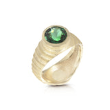 Lunar ring with undulating textured 18ct gold and set with a vibrant green tourmaline. The design is based on the throwing of a ceramic pot, with the finger indentations up the walls, giving an almost planetary feel. Lunar ring by Sarah Herriot.