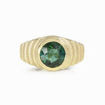Lunar ring with undulating textured 18ct gold and set with a vibrant green tourmaline. The design is based on the throwing of a ceramic pot, with the finger indentations up the walls, giving an almost planetary feel. Lunar ring by Sarah Herriot.