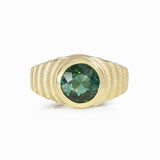 Lunar ring with undulating textured 18ct gold and set with a vibrant green tourmaline. The design is based on the throwing of a ceramic pot, with the finger indentations up the walls, giving an almost planetary feel. Lunar ring by Sarah Herriot.