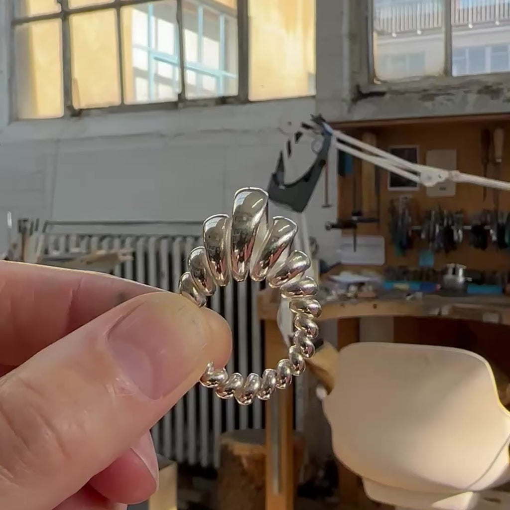 Silver ring made from single looping thread, a modern take on an eternity ring.  Acrobat ring by Sarah Herriot.