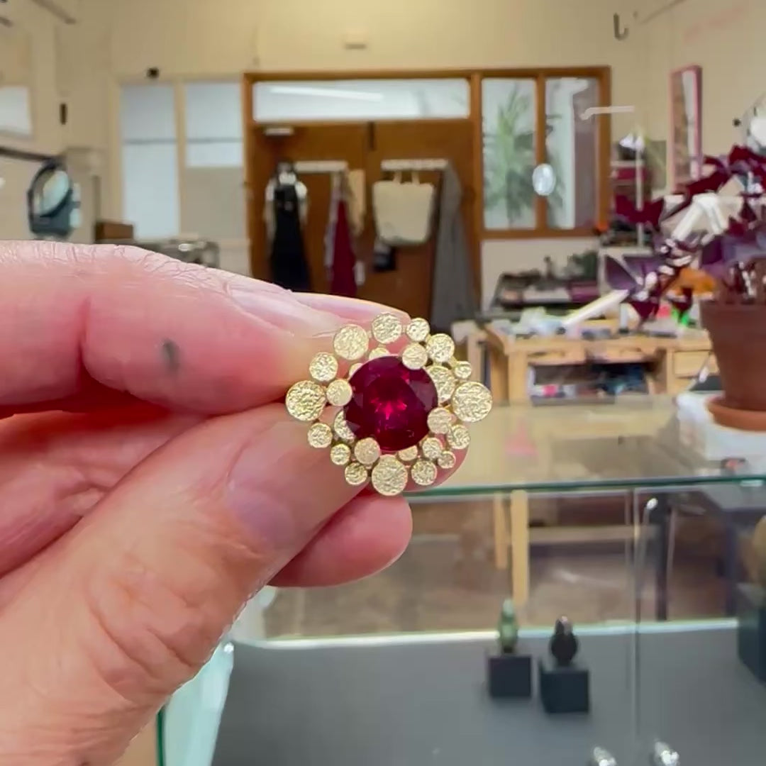Staffa ring formed of undulating columns of 18ct gold and a stunning deep red rubellite tourmaline nestled within.  Staffa ring by Sarah Herriot.