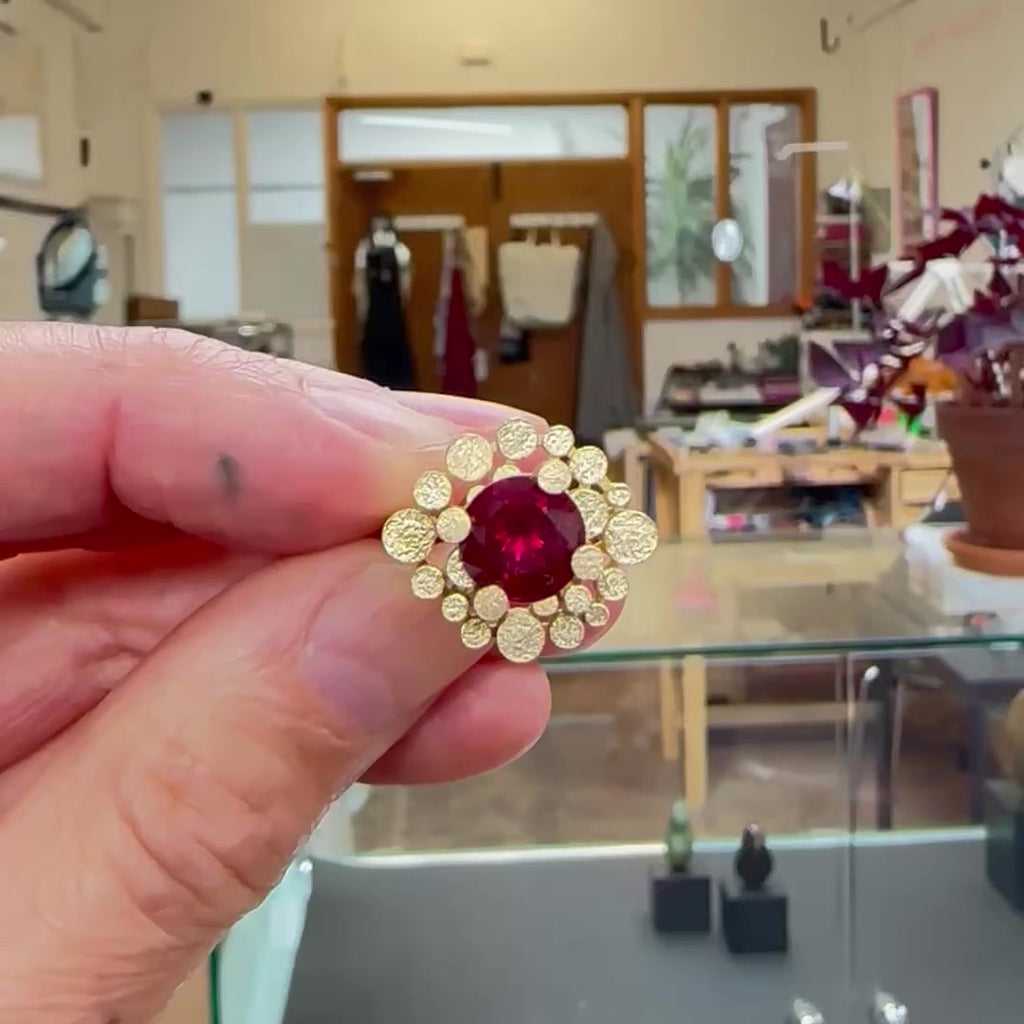 Staffa ring formed of undulating columns of 18ct gold and a stunning deep red rubellite tourmaline nestled within.  Staffa ring by Sarah Herriot.