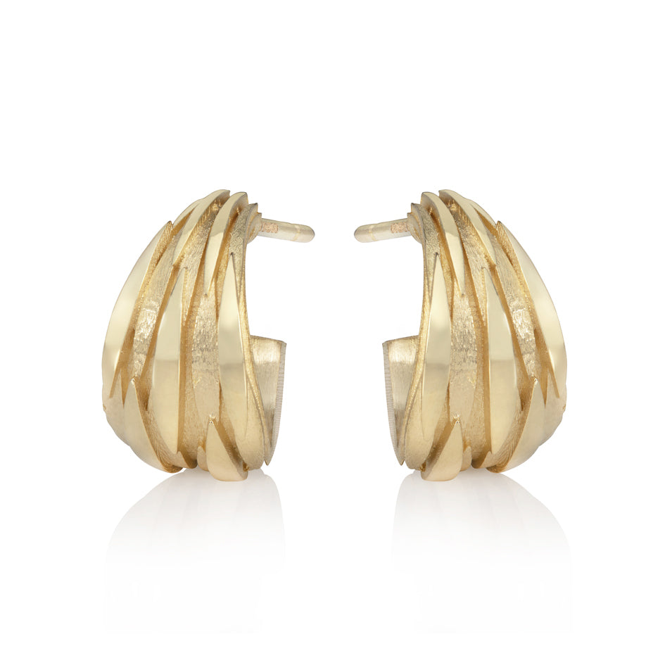 Shoal earrings, layers of fish fly around the cuff creating a beautiful streaming pattern in 18ct gold.  The design is based on shoals of fish swimming in a streaming ball in order to protect themselves, perhaps these earrings are a talisman. Shoal earrings by Sarah Herriot.