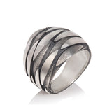 Shoal ring is constructed of three layers of silver fish revolving round the surface, oxidisation accentuates and defines the movement. Shoal ring by Sarah Herriot.