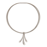 Splash neckpiece in polished and sandblasted silver with rhodium plating on a nine strand steel neck wire by Sarah Herriot.