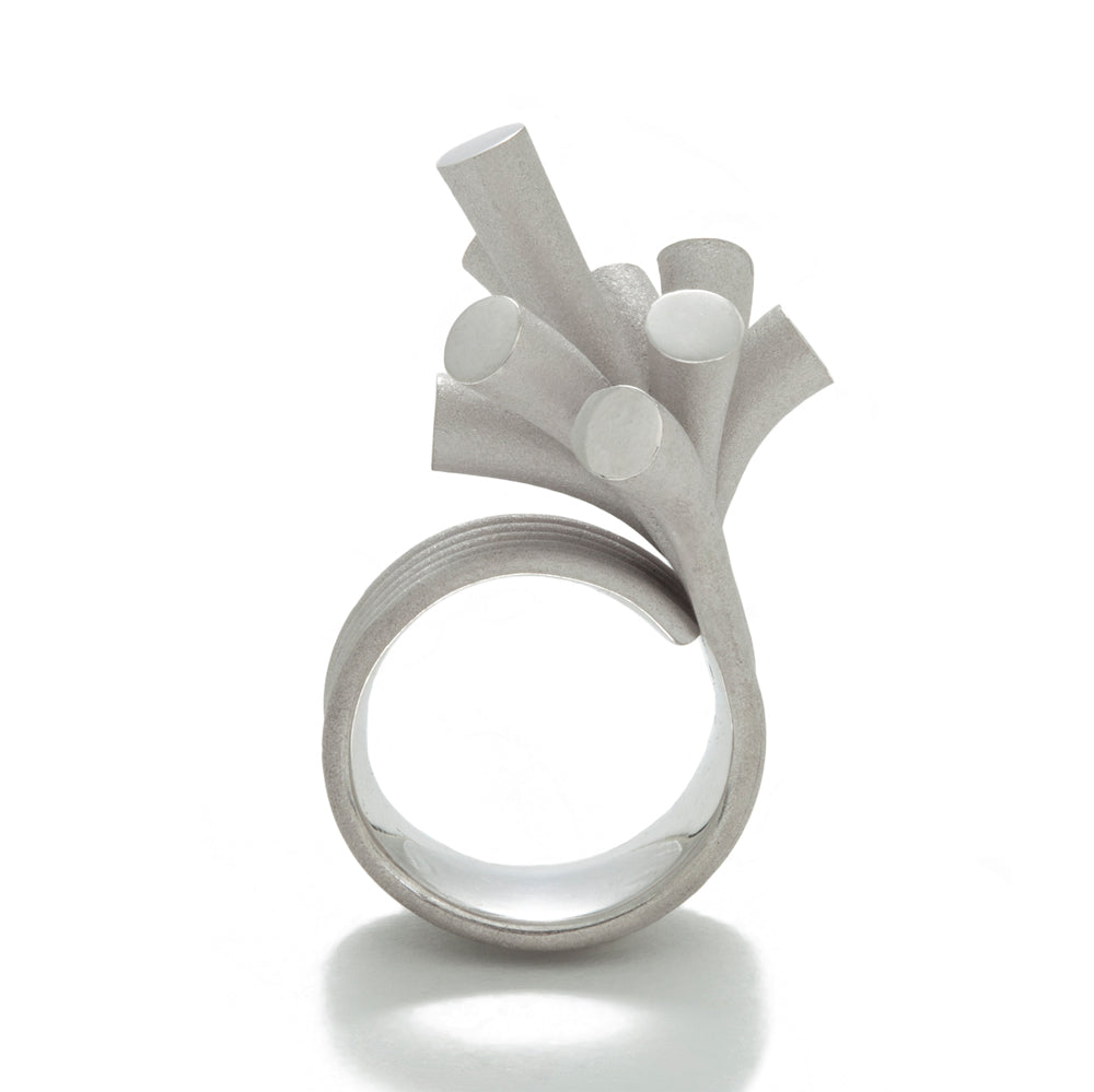 Splash ring in silver with sandblasted surfaces and rhodium plating by Sarah Herriot.