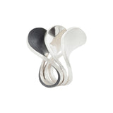A set of three silver spooning rings create a theatrical and dynamic form for the finger, combining three different finishes to accentuate the sculptural nature of the piece.  Spooning rings by Sarah Herriot.
