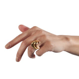 A set of three silver spooning rings create a theatrical and dynamic form for the finger, combining three different colours of gold plate to accentuate the sculptural nature of the piece, green yellow and rose. Spooning rings by Sarah Herriot.