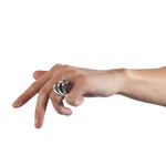 A set of three silver spooning rings create a theatrical and dynamic form for the finger, combining three different finishes to accentuate the sculptural nature of the piece.  Spooning rings by Sarah Herriot.