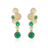 Staffa earrings are formed of undulating discs of 18ct gold with rich emeralds. Staffa earrings by Sarah Herriot.