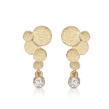 Staffa earrings are formed of undulating discs of 18ct gold with glittering diamond drops. The design is inspired by Fingal's cave on the Isle of Staffa off the west coast of Scotland. Textured surfaces echo the natural basalt rock formations. STaffa earrings by Sarah Herriot.