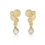 Staffa earrings are formed of undulating discs of 18ct gold with glittering diamond drops. The design is inspired by Fingal's cave on the Isle of Staffa off the west coast of Scotland. Textured surfaces echo the natural basalt rock formations. STaffa earrings by Sarah Herriot.