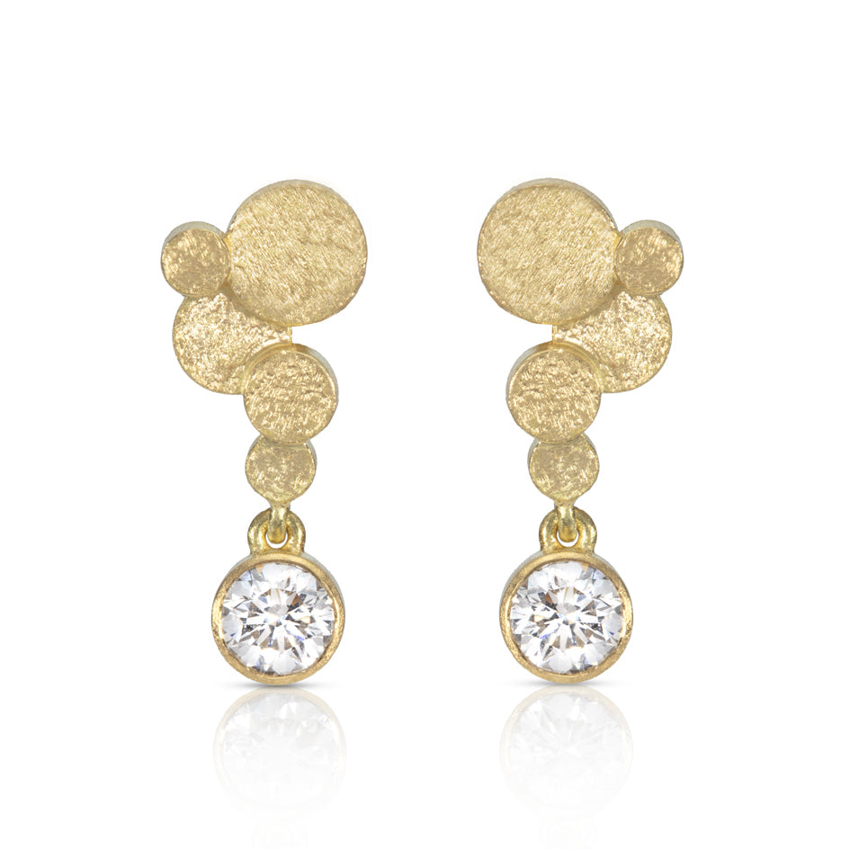 Staffa earrings are formed of undulating discs of 18ct gold with glittering diamond drops. The design is inspired by Fingal's cave on the Isle of Staffa off the west coast of Scotland. Textured surfaces echo the natural basalt rock formations. STaffa earrings by Sarah Herriot.