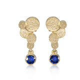Staffa earrings are formed of undulating discs of 18ct gold with rich blue sapphire drops.  Staffa earrings by Sarah Herriot.