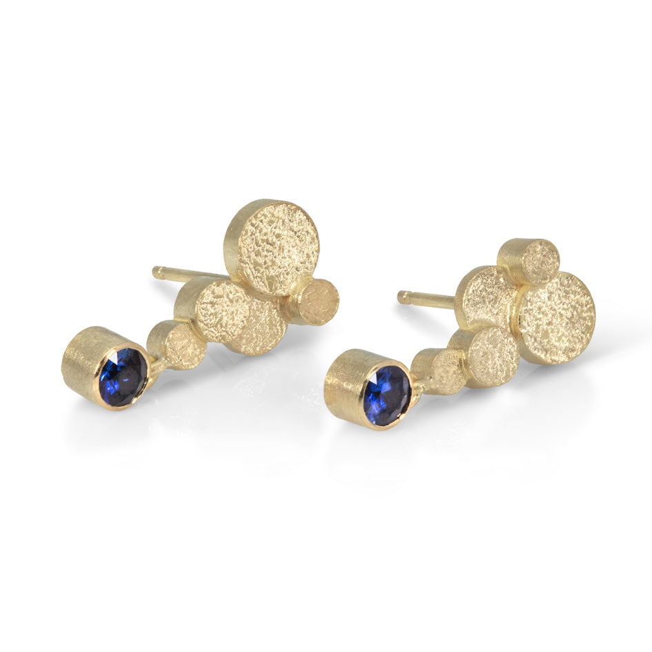 Staffa earrings are formed of undulating discs of 18ct gold with rich blue sapphire drops.  Staffa earrings by Sarah Herriot.